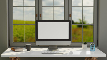 Fototapeta premium Blank screen desktop computer in a minimal office room with decorations and copy space, 3d rendering