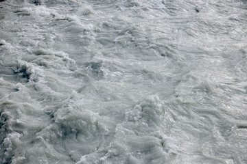 Raging muddy water of a mountain river