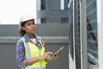 Female engineer or woman technician work with digital tablet for check or maintenance electrical...