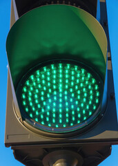 Traffic light in green light lit day 