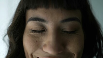 Young woman with eyes shut smiling trying to meditate