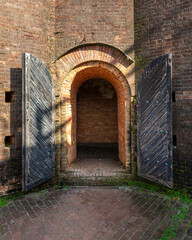Arched Brick Doorway with Black Doors - 522083184