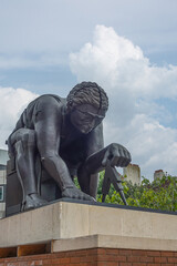 London, Great Britain - July 3, 2022: Closeup of gray Newton Statue on pedestal in front yard of...