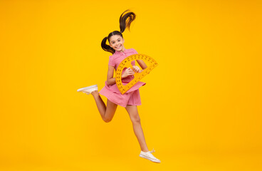 Fototapeta na wymiar School supplies. Teenager school girl on yellow background. Crazy jump, jumping kids.