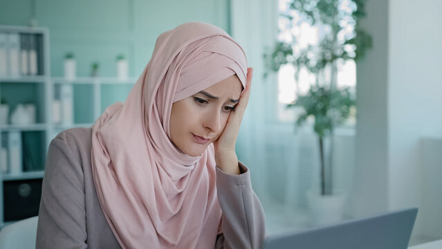 Arabian Worker User Islamic Businesswoman Muslim In Hijab In Office Sitting Table Looking Laptop Screen Reading Bad News Failure Lost Job Mail Sad Frustrated Losing Finance Bankruptcy Problem Denial