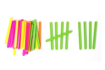 counting colorful sticks for the purposes of early education, development, learning to count and play. Banner with colored sticks on isolated white background