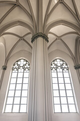 Fototapeta premium Bright interior of the church with stained-glass windows, view from below.