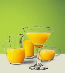 Orange Juice on a color background, in bright light. Glass of Juice with blended orange. Summer tropical cocktail.