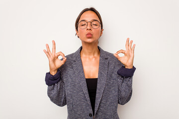 Young hispanic woman isolated on white background relaxes after hard working day, she is performing yoga.