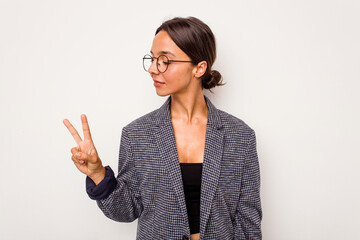 Young hispanic woman isolated on white background joyful and carefree showing a peace symbol with fingers.