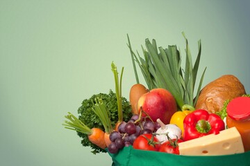 Shopping bag full of fresh groceries, grocery shopping concept on background