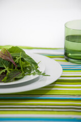 Detox food on a white plate with a glass of water