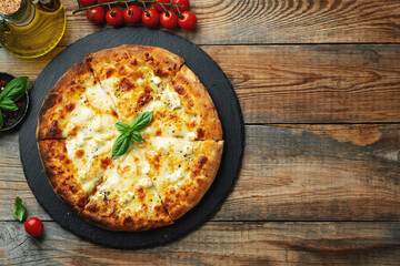 A slice of hot Italian pizza with stretching cheese. Pizza four cheeses with basil.