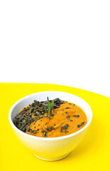 Homemade pumpkin cream soup bowl background