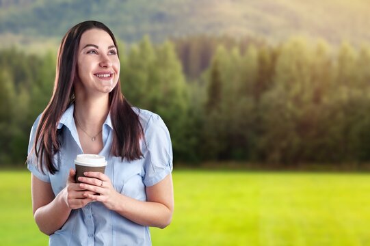 Portrait image of a beautiful young woman drinking coffee and relaxing with nature views