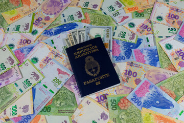An Argentine passport with dollars and Euros inside on Argentine Peso banknotes.