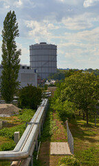 Gas tank with pipe in Europe. Landscape on sunny summer day. Contribution to scarce gas stocks and high prices. Stuttgart, Gaisburg.