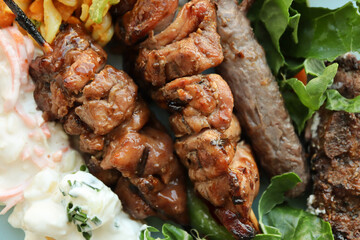 Braaied meat including boerewors sausage, lamb chops and chicken kebabs. South African braai. Barbecue, BBQ 