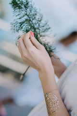 women's hands decorated with various signs and symbols with bracelets on their wrists