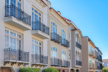 Row of mediterranean houses with wrought iron railings on its window balconies in San Francisco, CA