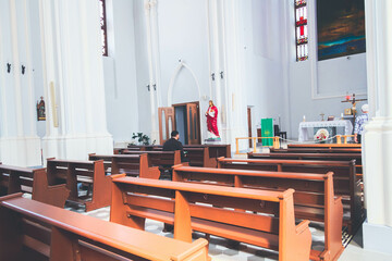 People pray in the church. Church parish. Believers sit on benches in the hall.