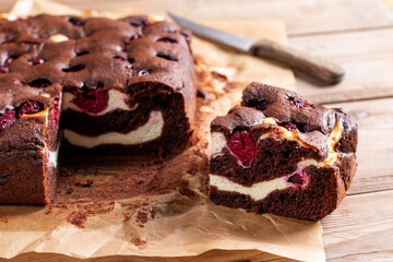 Homemade brownies with fresh berry on old wooden background