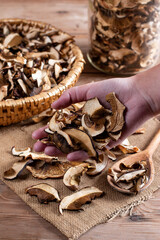 Collect and dry mushrooms in autumn, porcini mushrooms - a delicious ingredient for sauces and goulash on a wooden table