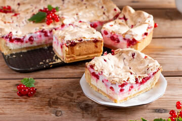 Homemade cottage cheese casserole garnished with redcurrant on wooden table