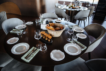 Beautifully organized event - round served table banquet ready for guests. Elegant dinner table