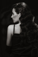 Portrait of elegant woman in vintage retro style of black and white Hollywood film with makeup and...