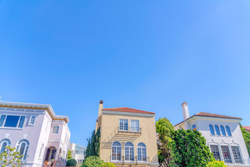 Fototapeta na wymiar Three houses in a low angle view at San Francisco, California