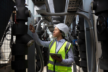 Close up great woman in manufacturing, female system engineer with safety PPE walk check at site...