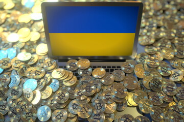 Laptop with flag of Ukraine and pile of bitcoins. Cryptocurrency mining and national regulations concepts, 3d rendering