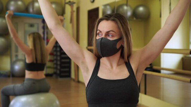 Slow motion of young female fitness coach instructor