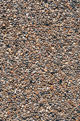 background, texture of small stones glued together to create a pedestrian zone or bike paths, vertical shot.