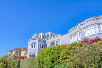 Villa exterior with purple gray walls and picture windows in San Francisco, CA