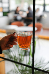 glass of tea in hand