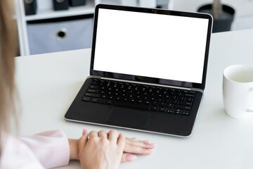 Business training. Studying woman. Computer mockup. Unrecognizable lady looking laptop blank screen in light room interior.