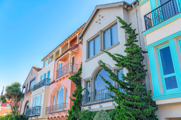 Fototapeta na wymiar Row of mediterranean three-storey houses with trees outdoors in San Francisco, California