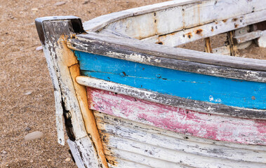 Bow of an old abandoned boat laying on a beach