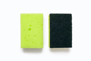 A green washcloth and a rough washcloth on a white background in the center of the image. Means for constant washing of ware and cleaning of the house. Tool for cleanliness and order