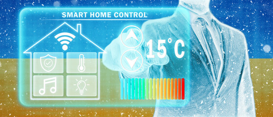 Frozen citizen of Ukraine adjusting heating temperature on a virtual screen of smart home...