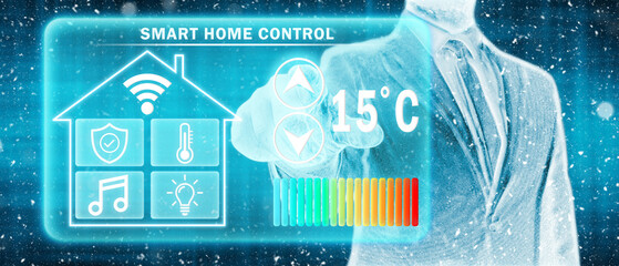 Frozen man adjusting heating temperature on a virtual screen of smart home controller, winter blizzard. Concept of forced thrift, energy war and increased price for natural gas for heating home