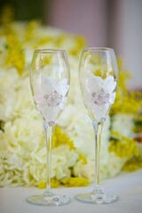 Two wedding glasses for champagne or wine. The concept of drinks and the wedding table layout.