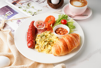 All Day Breakfast with beans, toast, croissants, chinese sausage, sauce, egg and latte served in a dish isolated on table side view of english breakfast