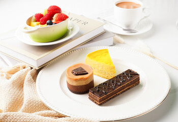 Assorted French Pastries with Fresh Fruits and Strawberries served in a dish isolated on wooden table side view
