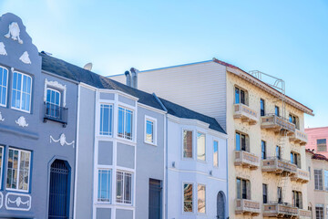 Townhomes with gray tones and a beige apartment building at San Francisco, California