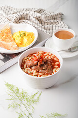 Beef and Tomato Bisque Pasta with kopi, tea, coffee, and bread served in a dish isolated on wooden table side view