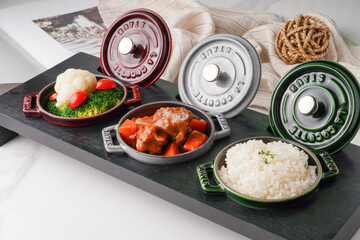 Beef Ribs with Rice served in a dish isolated on wooden table side view