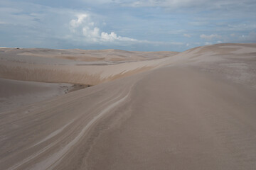 Fototapeta na wymiar Lençóis Maranhenses sand dunes and blue sky with clouds.